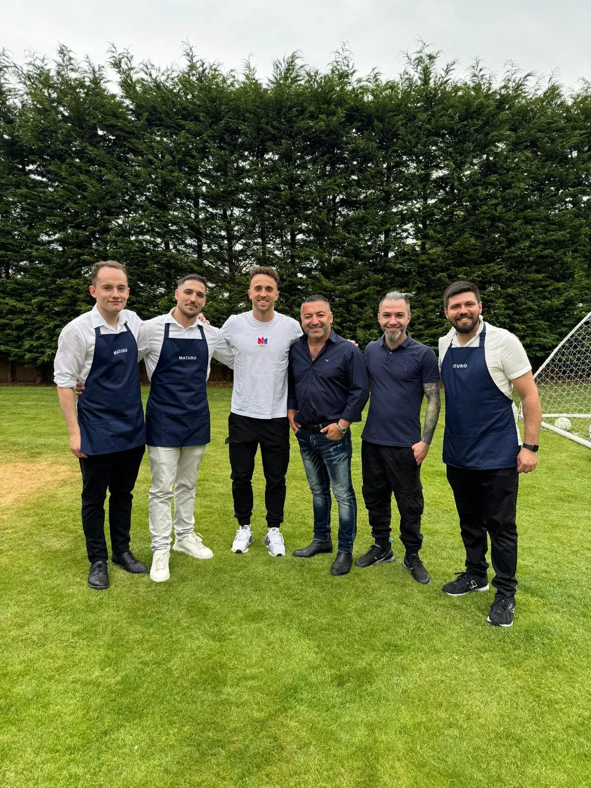 Okan Events hospitality team with a guest at a private outdoor event