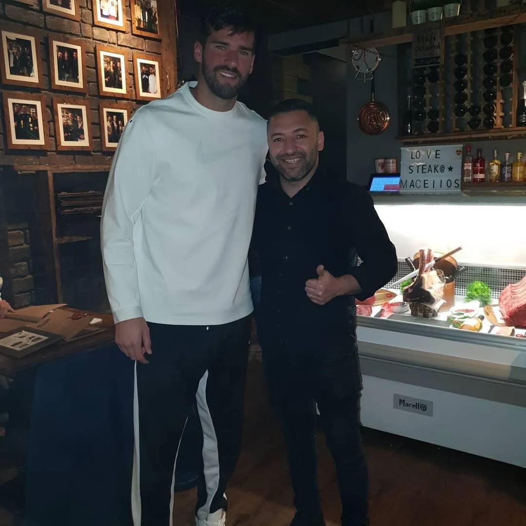 Guest with Okan Events beside a premium steak display