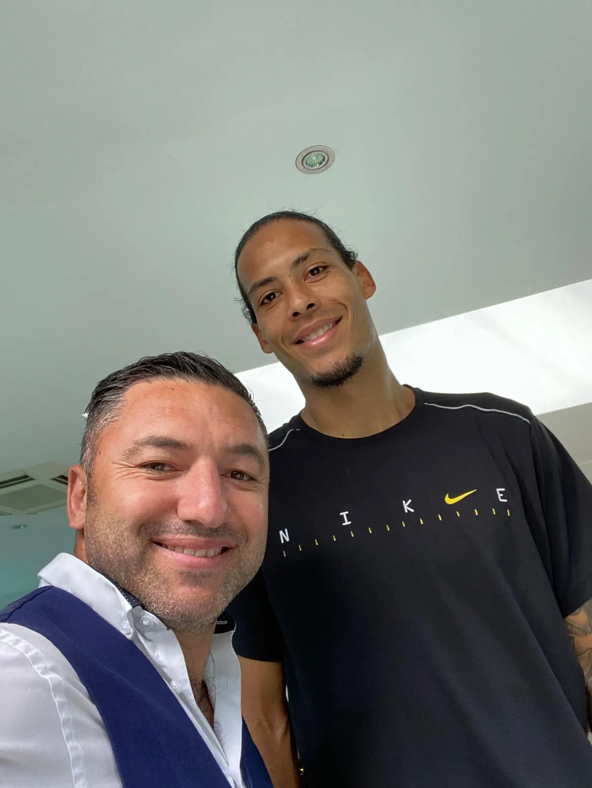 Okan Events host with a guest at a private indoor gathering